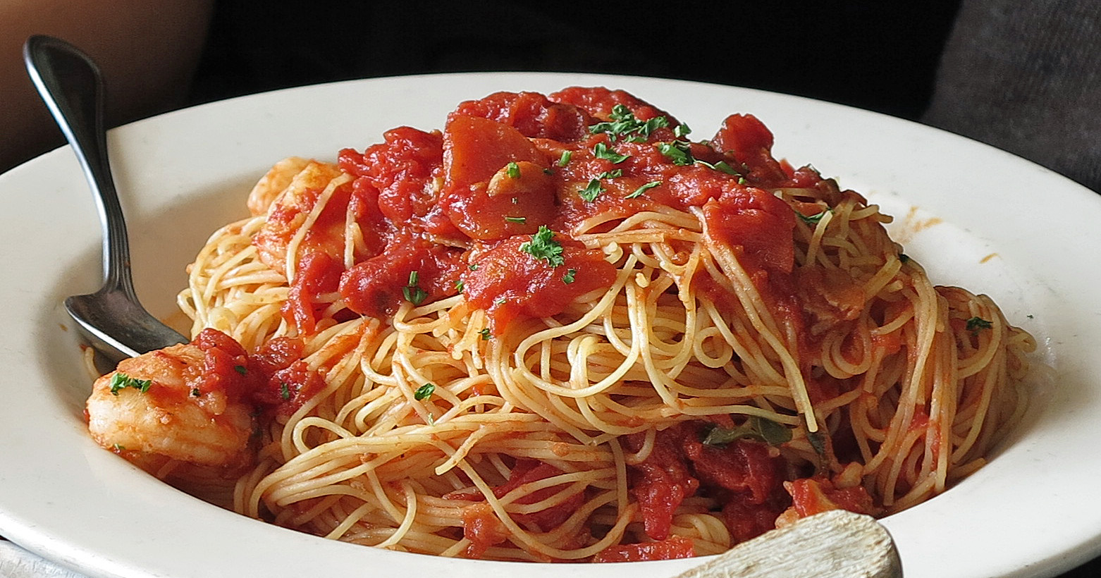 angel hair pasta with red sauce and garnish